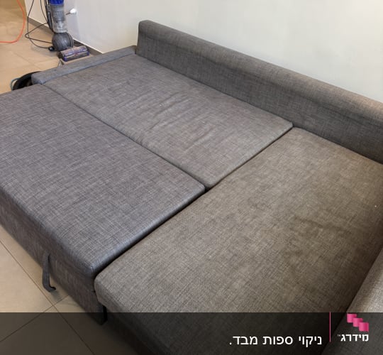 ספה אפורה עם שואב אבק בצד